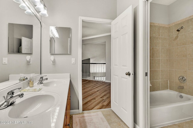 bathroom with tiled shower / bath, vanity, ornamental molding, and hardwood / wood-style flooring