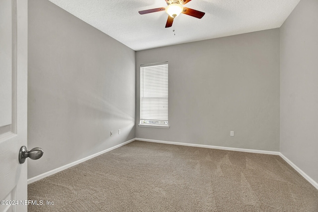 carpeted spare room with ceiling fan and a textured ceiling