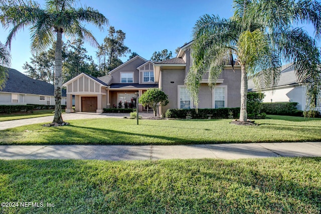 view of front of home with a front yard and a garage