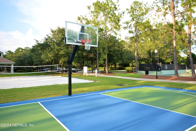 view of basketball court featuring volleyball court and a lawn