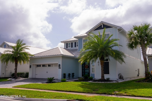 view of front facade with a front lawn and a garage