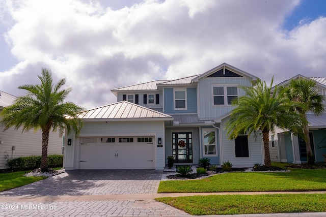 95 Caribbean Pl, Saint Johns, FL 32259 - craftsman house with a front lawn, a garage, decorative driveway, a standing seam roof, and metal roof