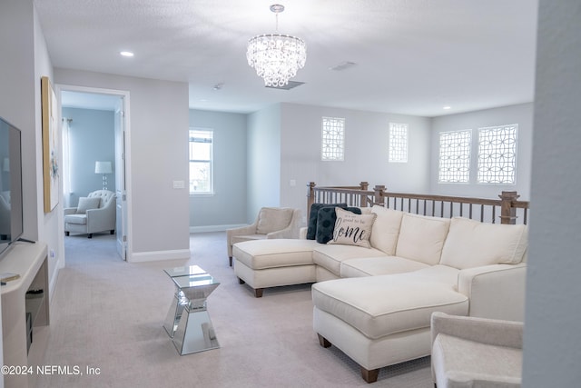 living room with an inviting chandelier and light colored carpet