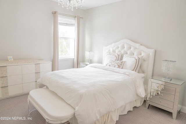 bedroom with light carpet and an inviting chandelier