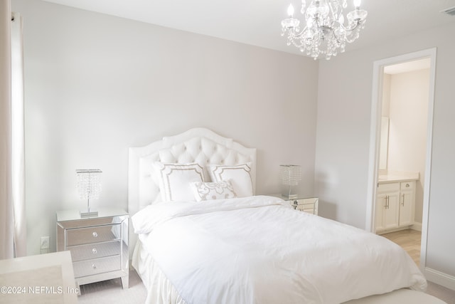 carpeted bedroom with an inviting chandelier and ensuite bath