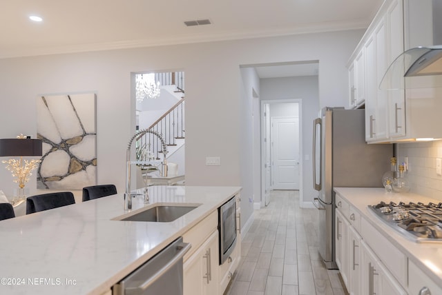 95 Caribbean Pl, Saint Johns, FL 32259 - kitchen with baseboards, white cabinets, tasteful backsplash, a sink, and stainless steel appliances