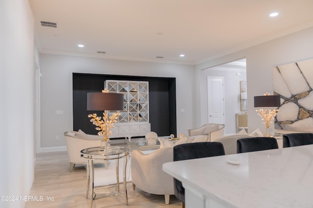 living room featuring crown molding and light hardwood / wood-style flooring