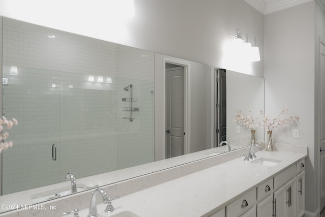 bathroom featuring a shower with door, vanity, and crown molding