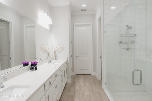 bathroom featuring vanity, hardwood / wood-style floors, crown molding, and walk in shower