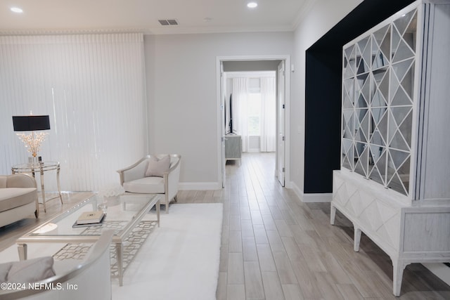 living room featuring light hardwood / wood-style floors and ornamental molding