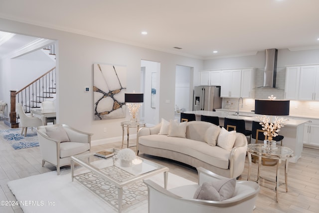 living room with ornamental molding and light wood-type flooring