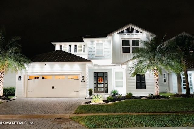 view of front of home featuring a yard and a garage