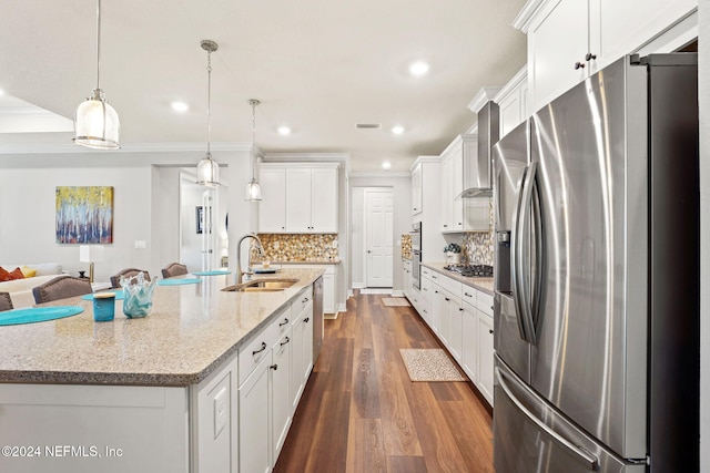 kitchen with white cabinets, dark hardwood / wood-style flooring, appliances with stainless steel finishes, a spacious island, and decorative light fixtures