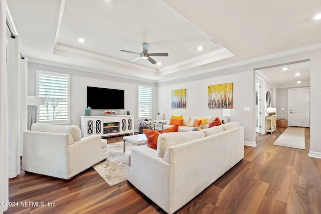 living area with a ceiling fan, ornamental molding, dark wood finished floors, and recessed lighting