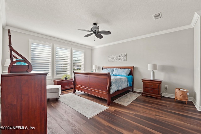 bedroom with ceiling fan, a textured ceiling, ornamental molding, and dark hardwood / wood-style floors