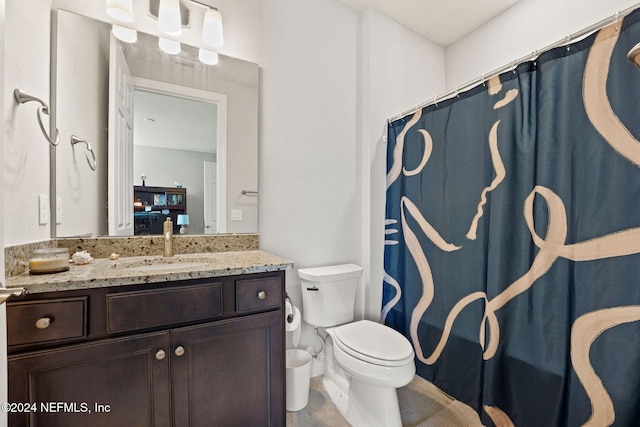 bathroom with vanity, curtained shower, and toilet