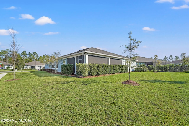 view of side of property with a lawn