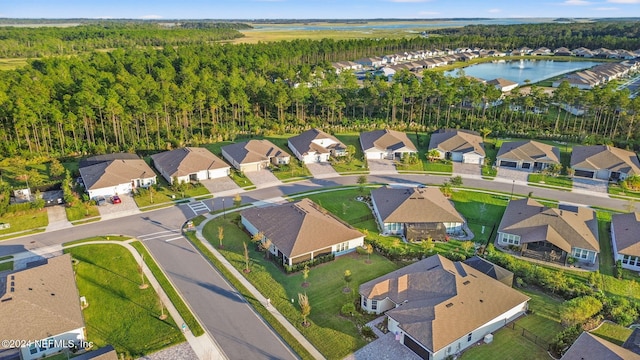 drone / aerial view with a residential view and a water view