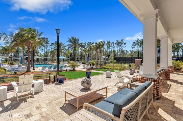 view of patio featuring fence and a community pool