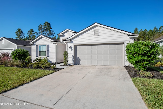 ranch-style home featuring a front yard and a garage