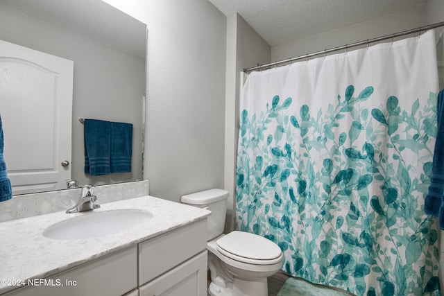 bathroom with vanity, toilet, a textured ceiling, and a shower with shower curtain