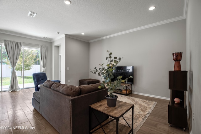 living room with a textured ceiling, dark hardwood / wood-style flooring, and ornamental molding