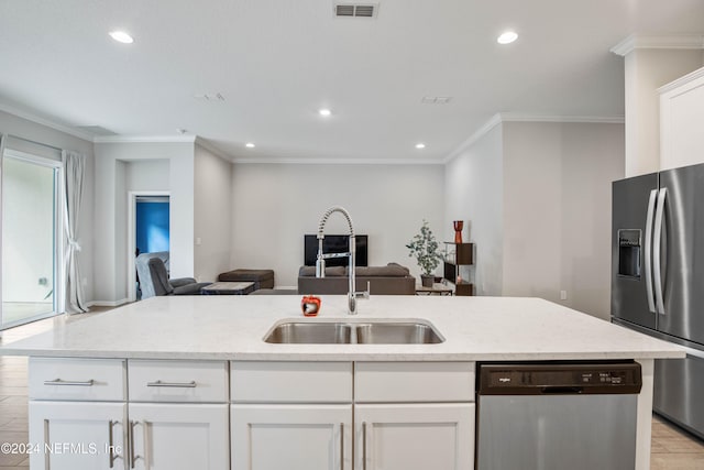 kitchen featuring ornamental molding, white cabinetry, stainless steel appliances, and sink