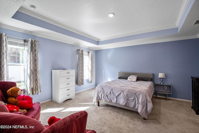 bedroom featuring a raised ceiling, ornamental molding, and light colored carpet