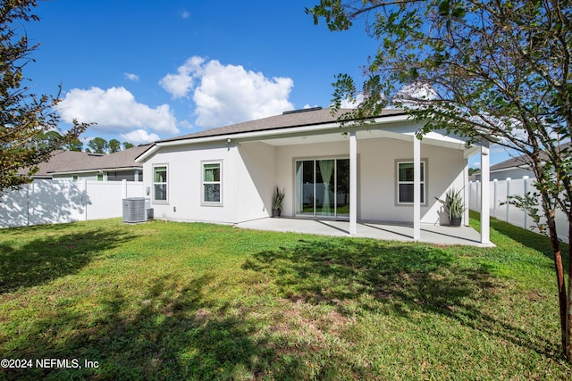 back of property featuring a patio, a lawn, and central AC unit