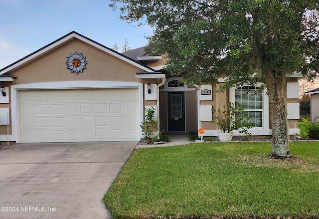 view of front facade featuring a front yard and a garage