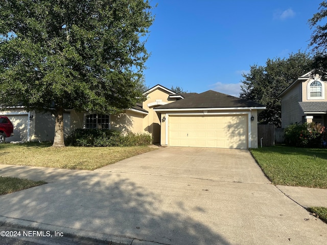 view of front of home featuring a garage and a front lawn