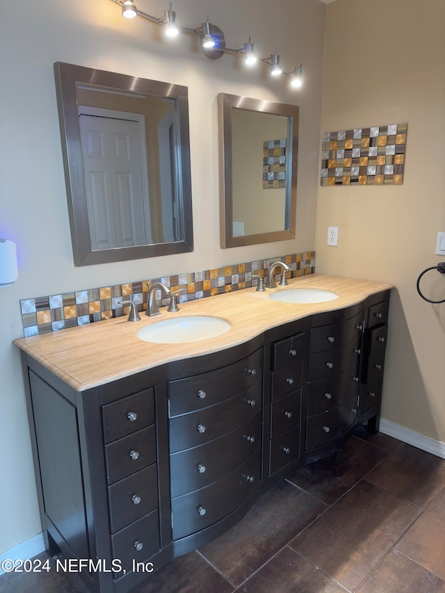 bathroom with vanity, tile patterned floors, and backsplash