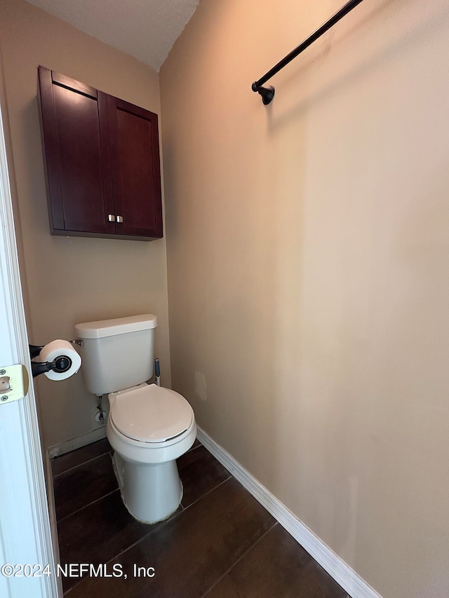 bathroom featuring toilet and tile patterned flooring