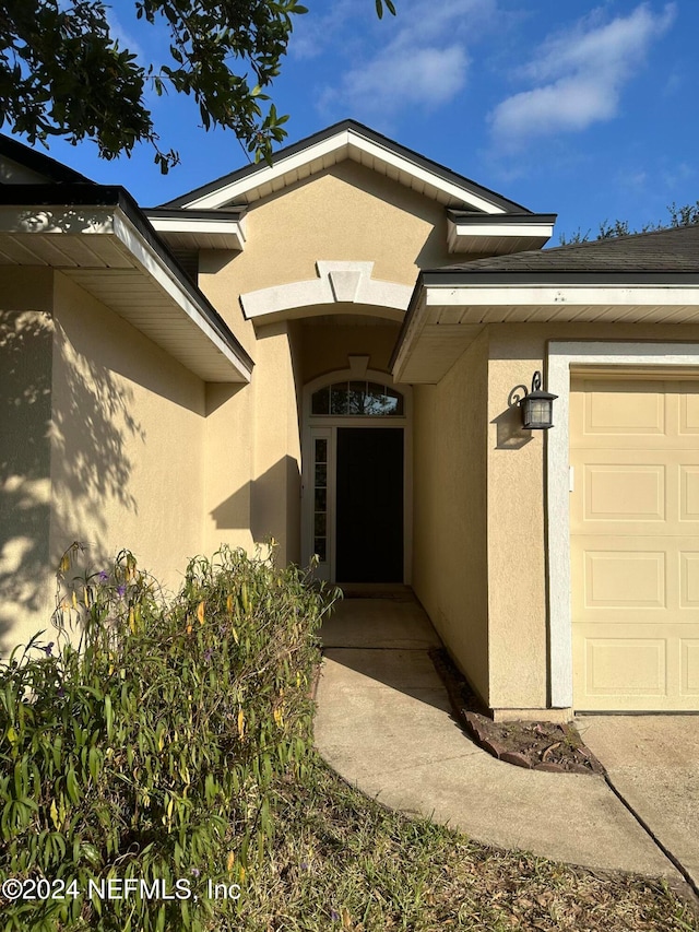 entrance to property featuring a garage