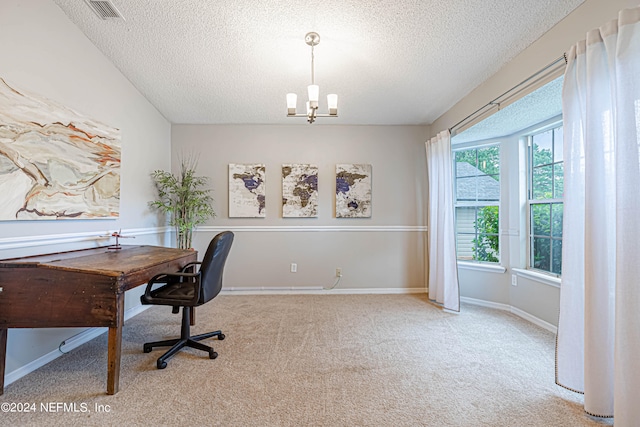 home office with a notable chandelier, light carpet, and a textured ceiling