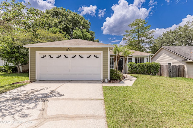 single story home with a front lawn and a garage