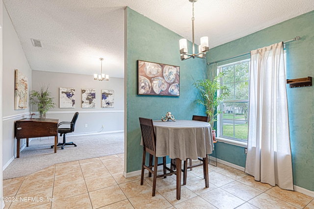 carpeted dining space featuring a textured ceiling and an inviting chandelier