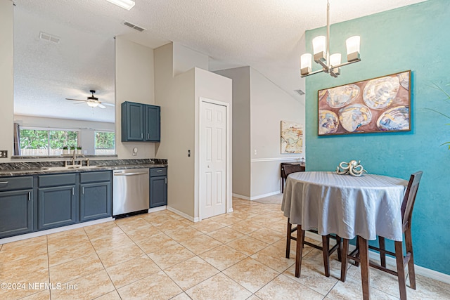 kitchen with dishwasher, ceiling fan with notable chandelier, a textured ceiling, hanging light fixtures, and light tile patterned floors