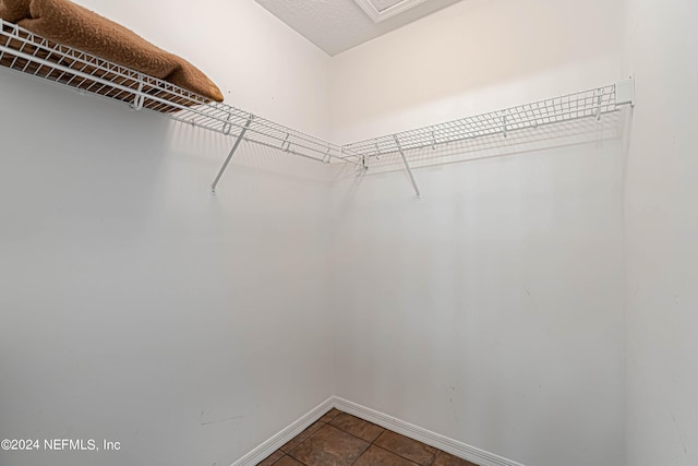 walk in closet featuring tile patterned flooring