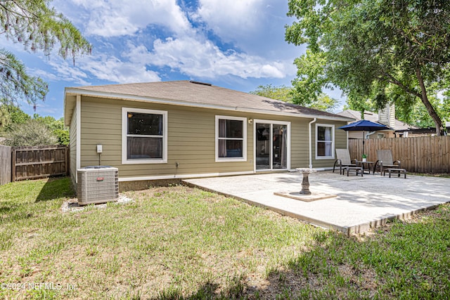 back of house featuring a yard, a patio area, and cooling unit