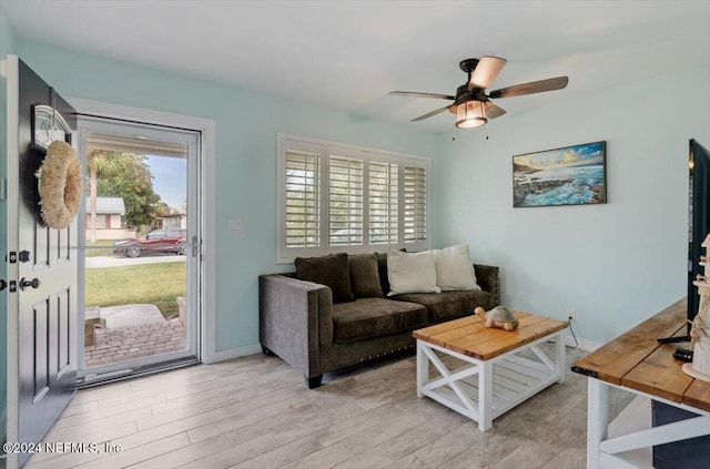 living room with ceiling fan and light hardwood / wood-style flooring