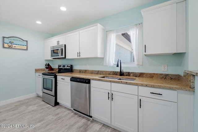 kitchen featuring white cabinetry, stainless steel appliances, and sink