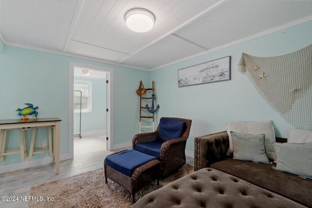 living room with light hardwood / wood-style floors and crown molding