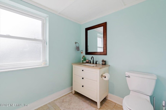 bathroom with vanity, tile patterned flooring, toilet, and plenty of natural light