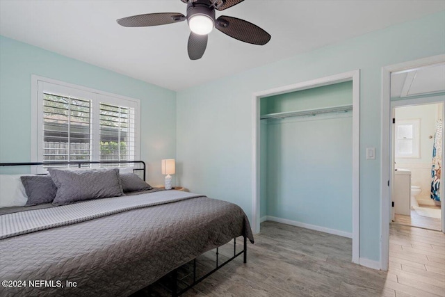 bedroom featuring a closet, ensuite bathroom, light wood-type flooring, and ceiling fan