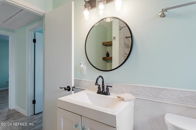 bathroom featuring vanity, hardwood / wood-style floors, and toilet