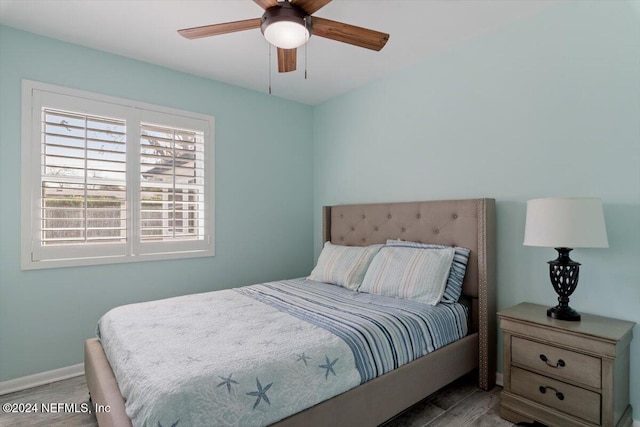 bedroom with hardwood / wood-style flooring and ceiling fan