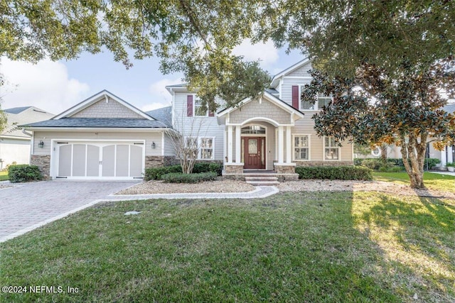 view of front of property with a garage and a front lawn