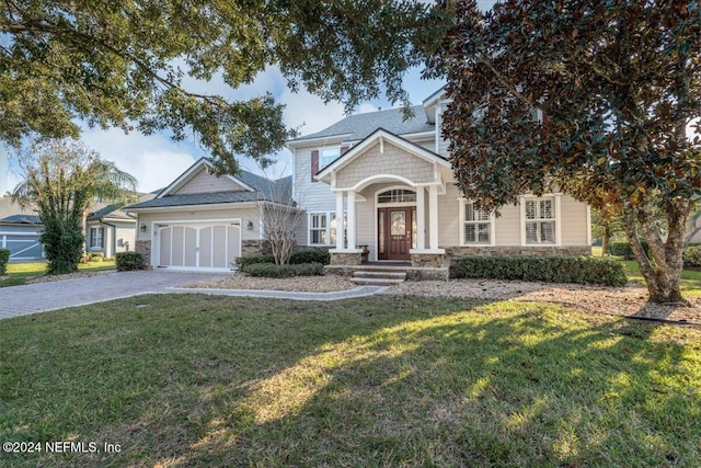 view of front facade featuring a front yard and a garage