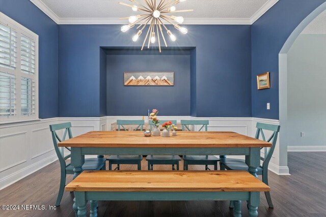 dining room with ornamental molding, a chandelier, and dark hardwood / wood-style floors